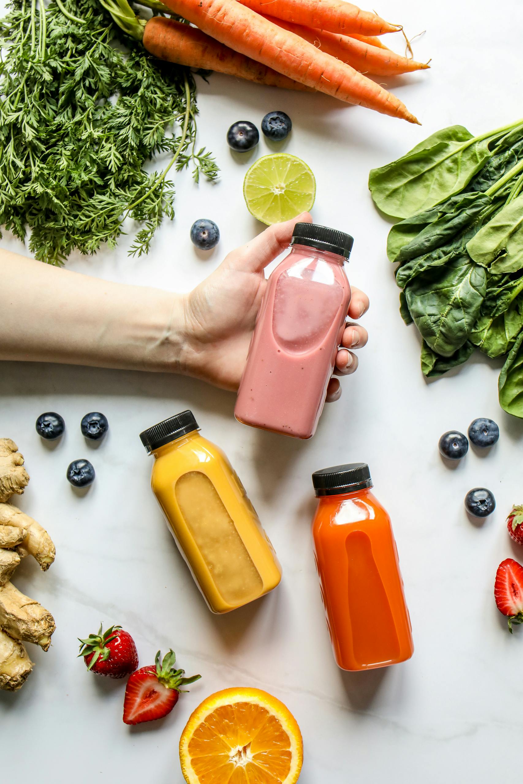 Vibrant smoothies surrounded by fresh fruits and vegetables, perfect for a healthy lifestyle.